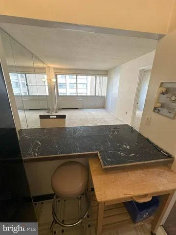 a room with pool table and windows