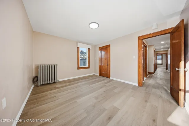 a view of an empty room with windows