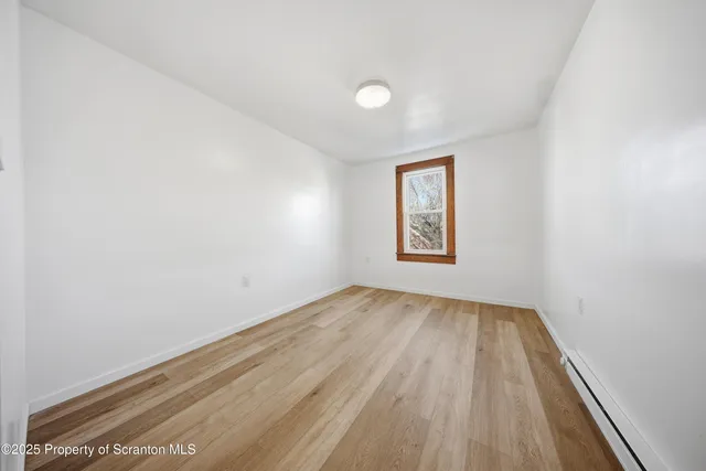 a view of a room with wooden floor and a sink