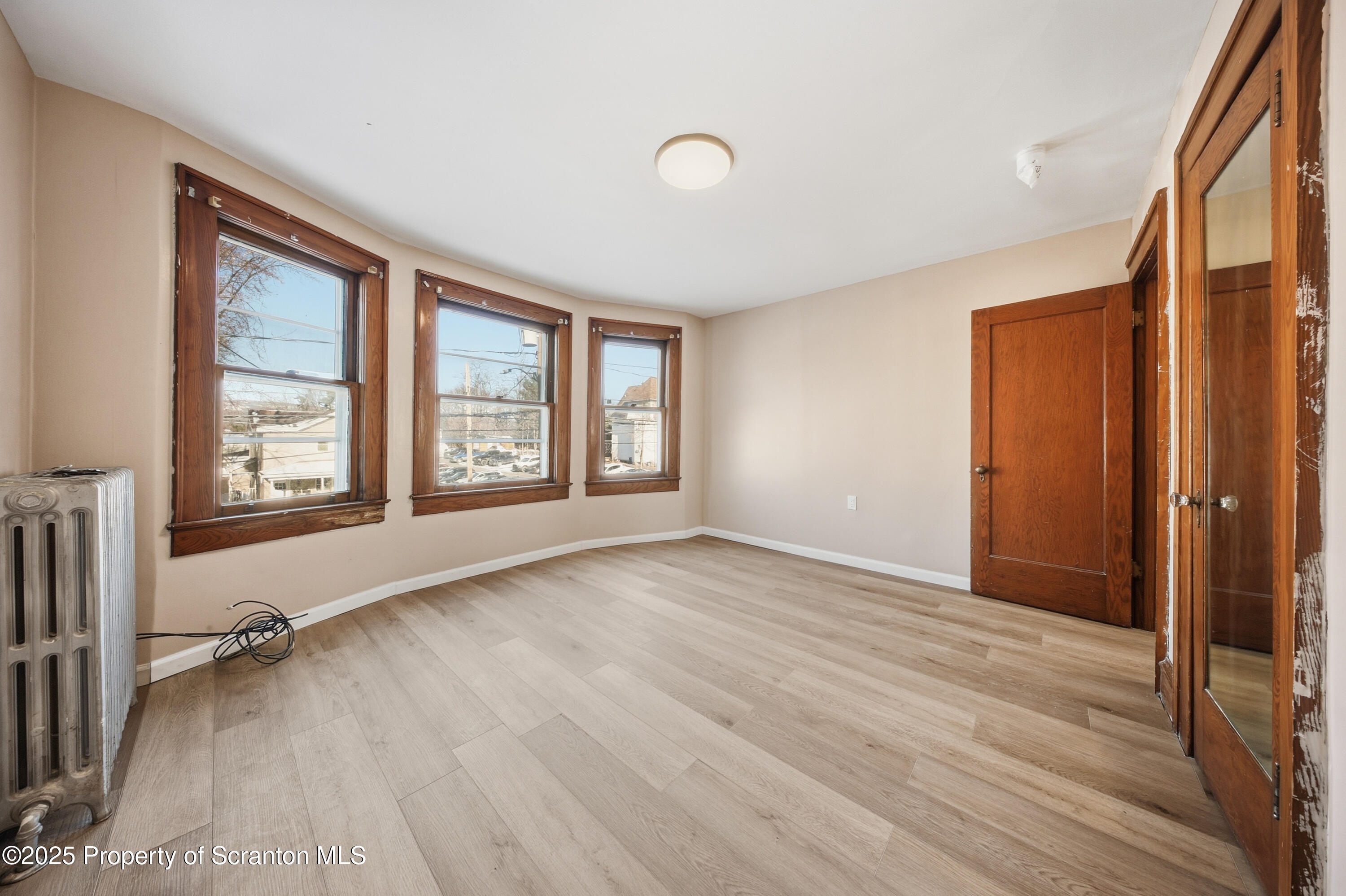 1312-14 North Washington Avenue Scranton, PA 18509 - Photo 16 of 22 an empty room with wooden floor and windows