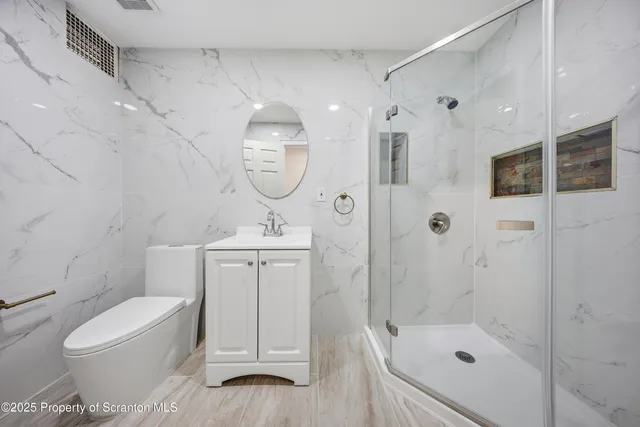 a bathroom with a tub sink and mirror