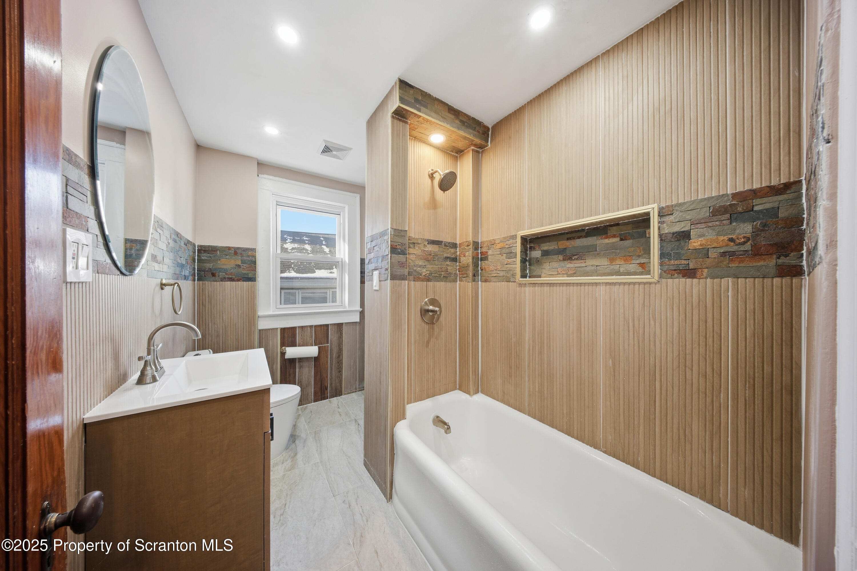 1312-14 North Washington Avenue Scranton, PA 18509 - Photo 20 of 22 a bathroom with a tub sink and mirror