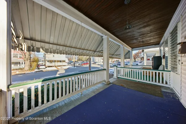 a view of a porch with wooden floor