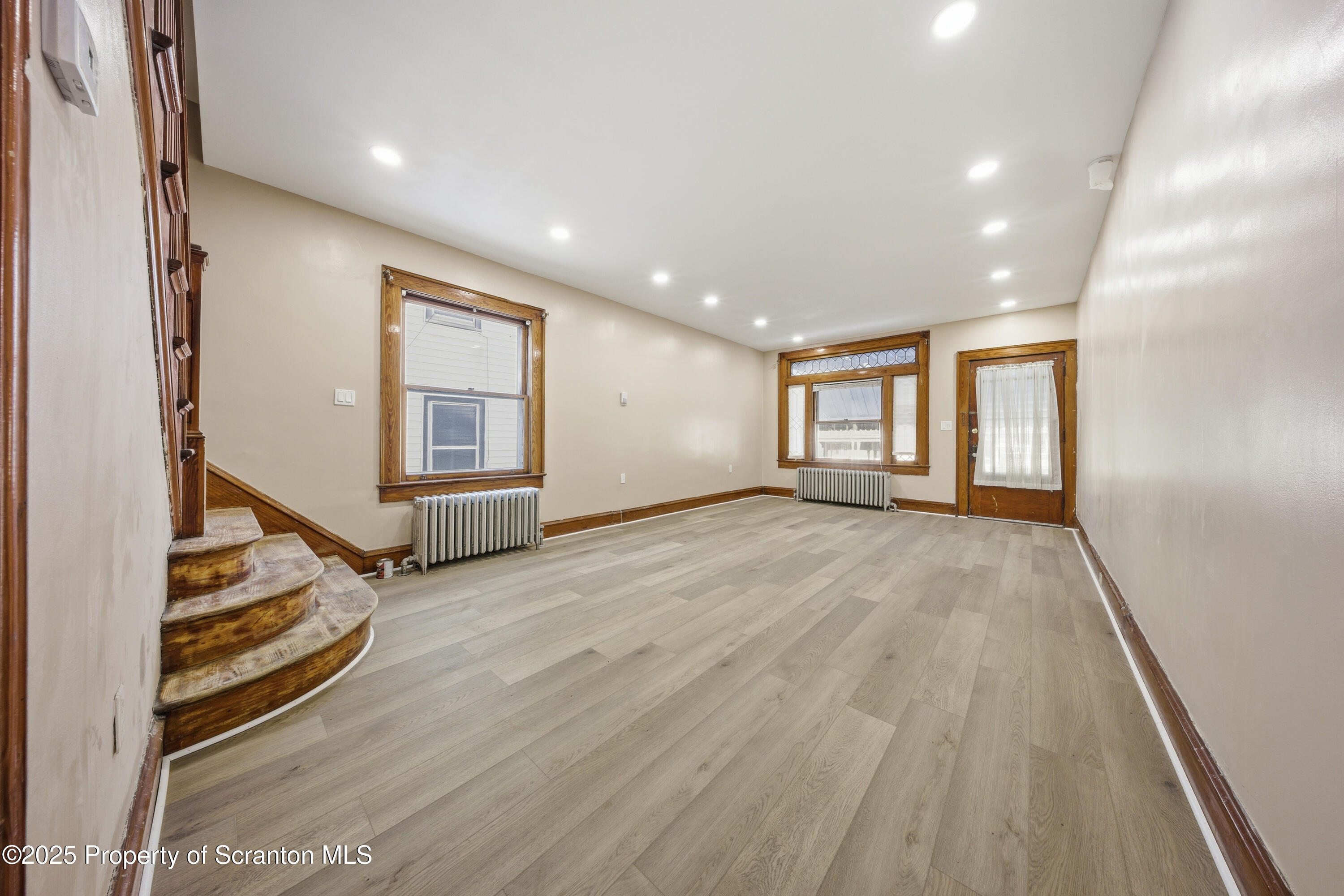1312-14 North Washington Avenue Scranton, PA 18509 - Photo 4 of 22 an empty room with wooden floor and windows