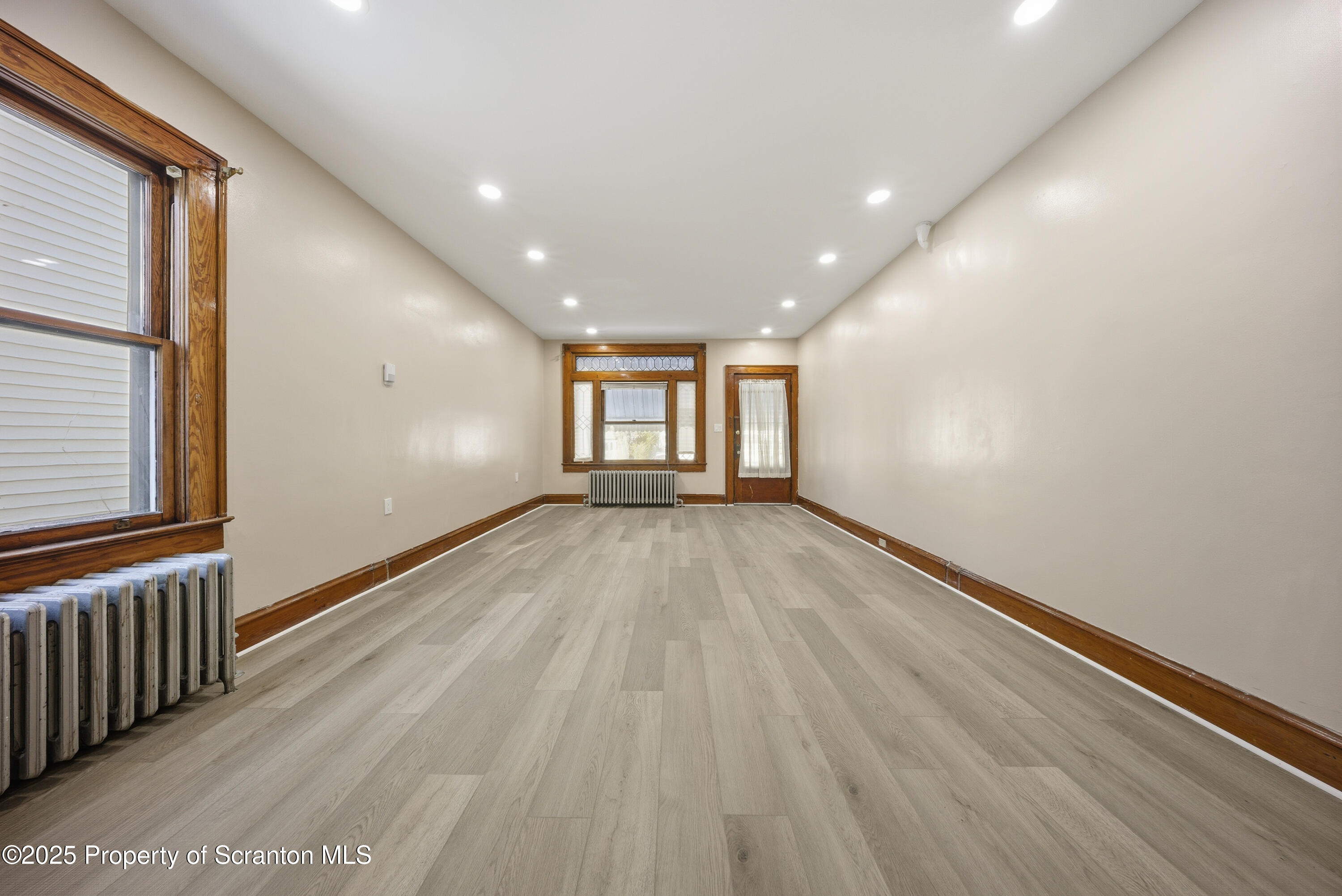 1312-14 North Washington Avenue Scranton, PA 18509 - Photo 5 of 22 a view of empty room with wooden floor and fan
