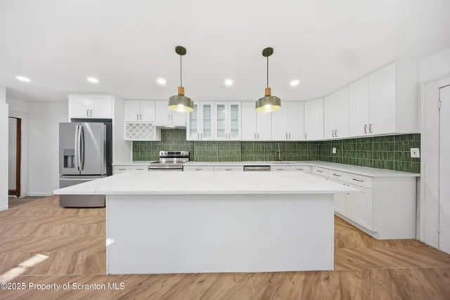 a kitchen with kitchen island granite countertop a sink a center island and cabinets