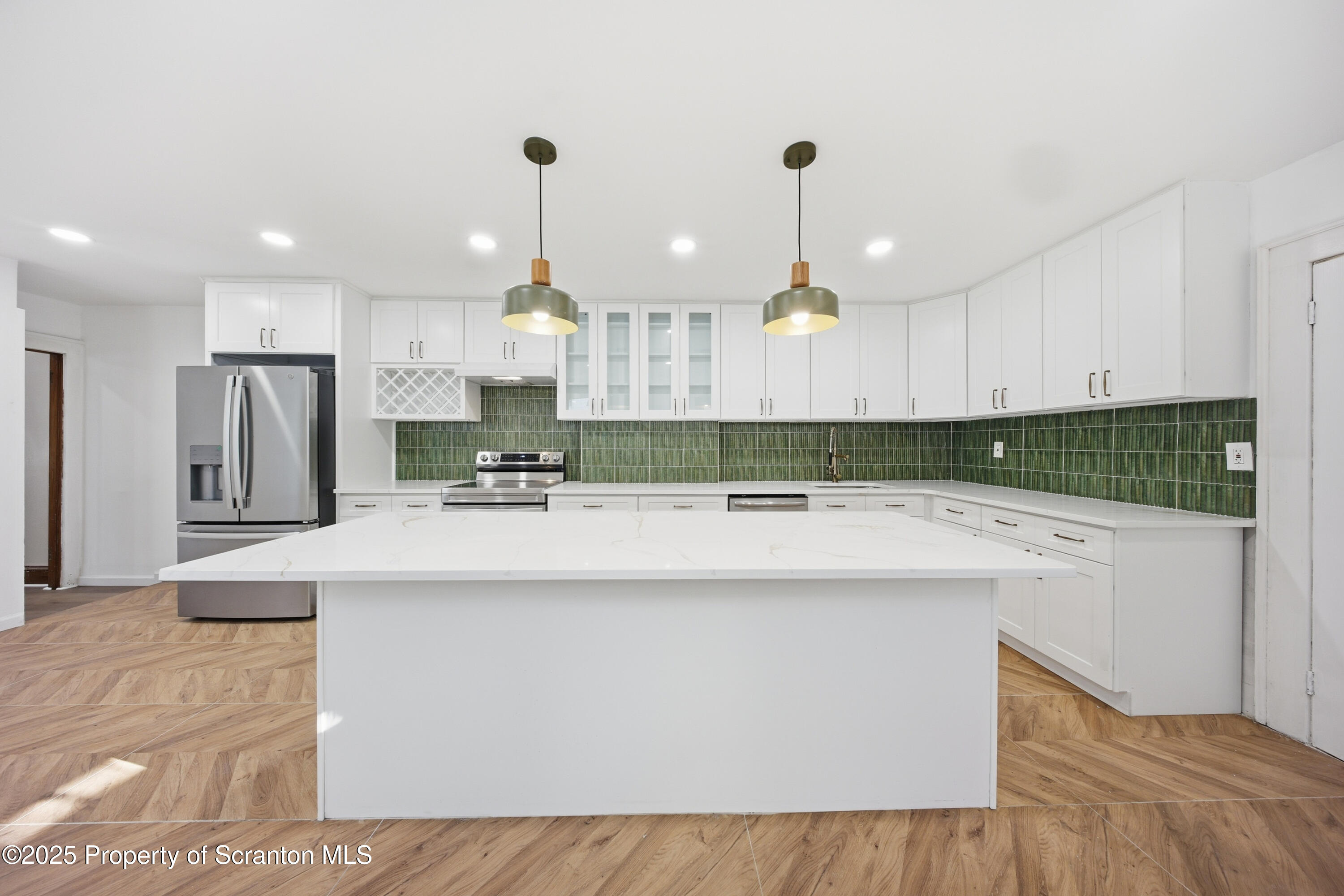 1312-14 North Washington Avenue Scranton, PA 18509 - Photo 6 of 22 a kitchen with kitchen island granite countertop a sink a center island and cabinets