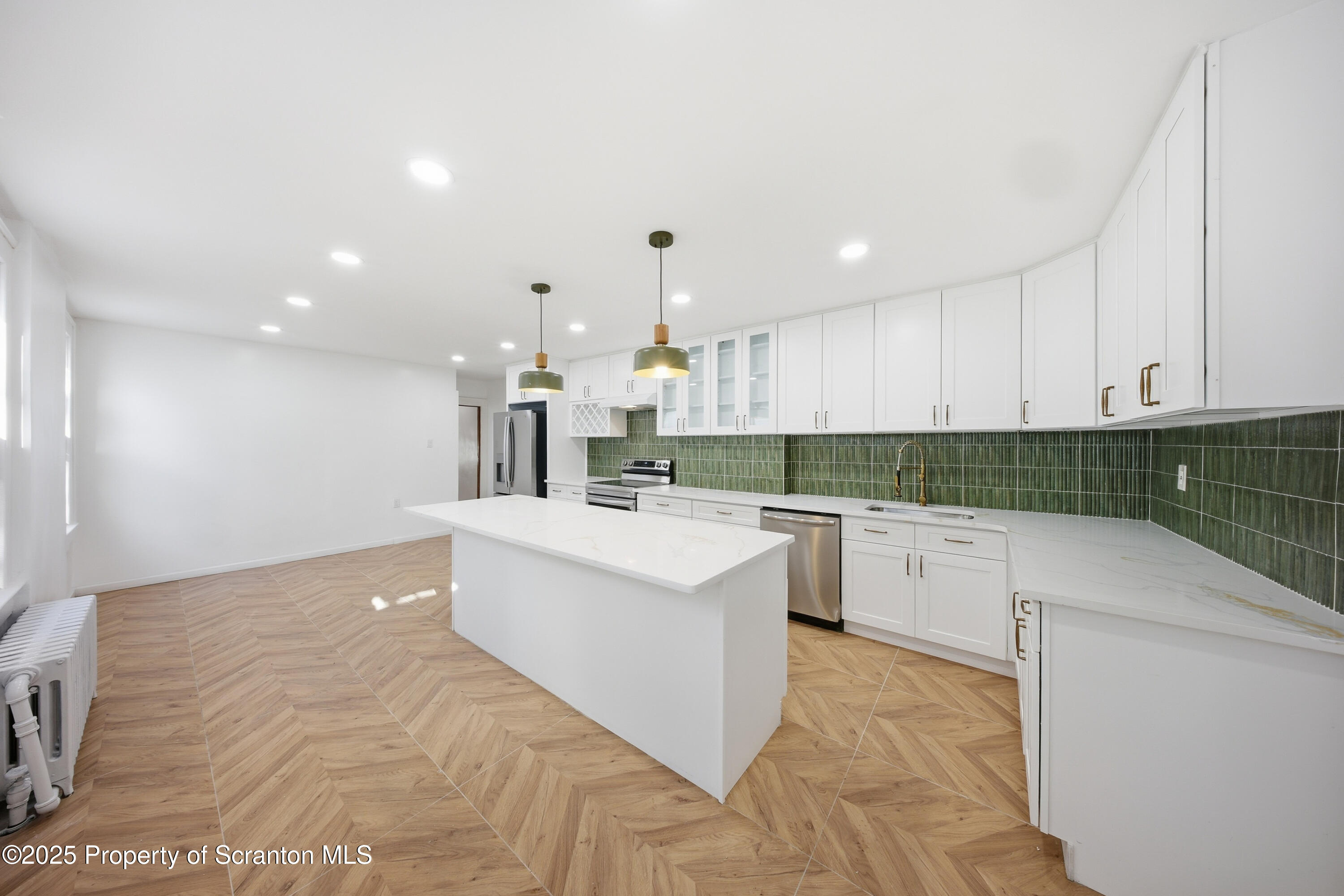 1312-14 North Washington Avenue Scranton, PA 18509 - Photo 9 of 22 a kitchen with white cabinets and white appliances
