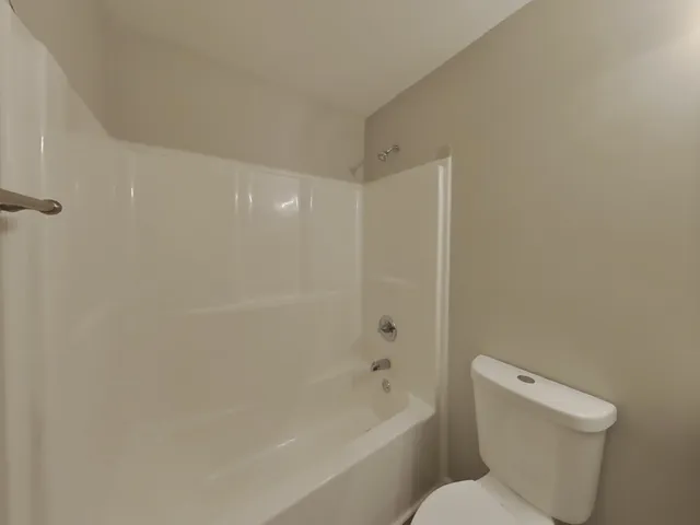 a bathroom with a toilet and a bathtub