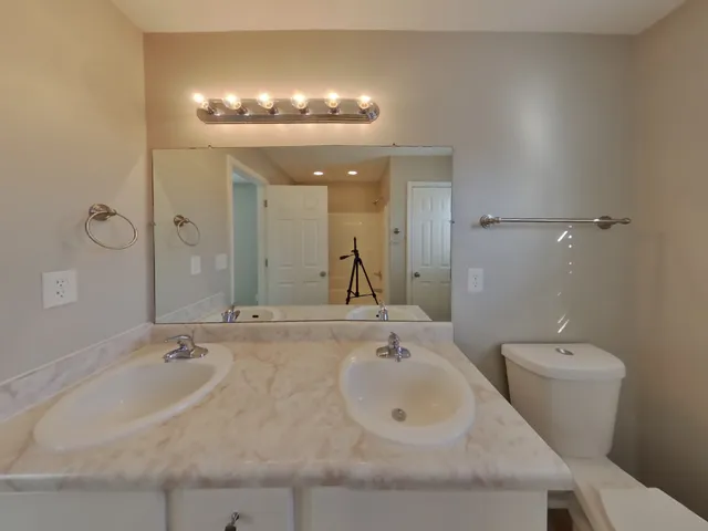 a bathroom with a sink and a large mirror