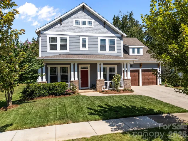 a front view of a house with a yard and porch