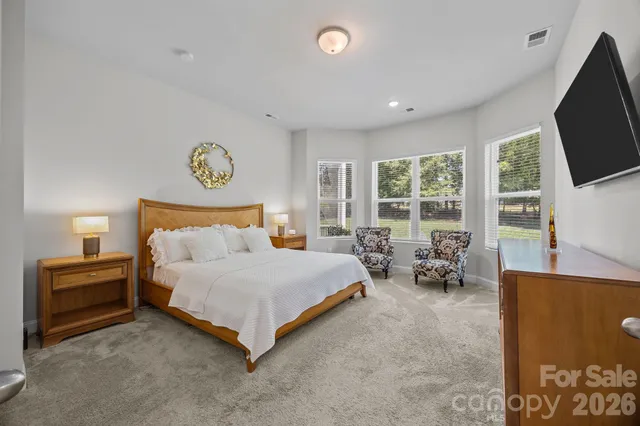 a spacious bedroom with a bed and cabinets