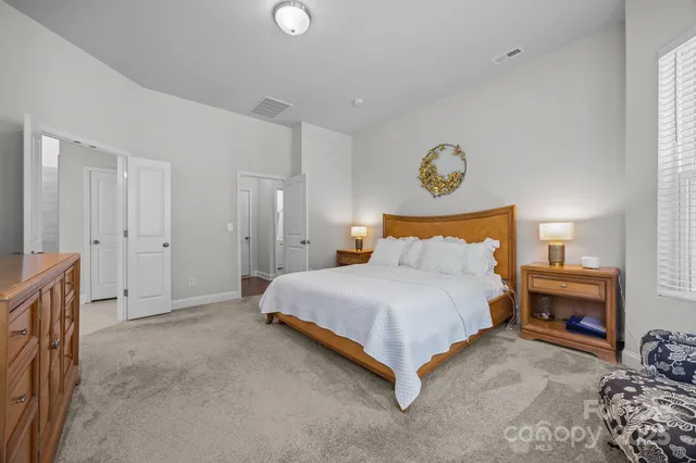 a spacious bedroom with a bed and cabinets