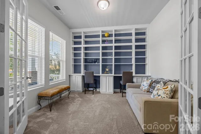 a bedroom with furniture and a large window