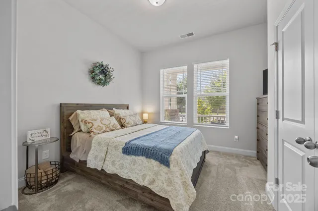 a bedroom with a large bed and a window