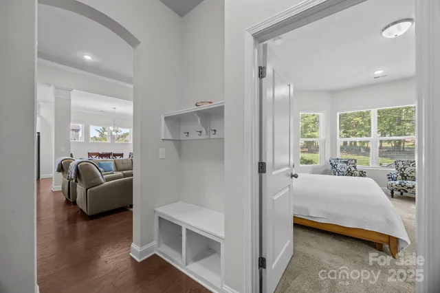 a bedroom with furniture and a large window