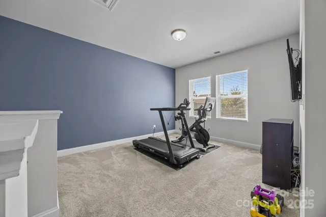 a room with gym equipment and a window
