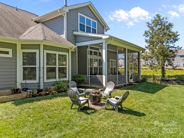 a view of a house with backyard sitting area and garden