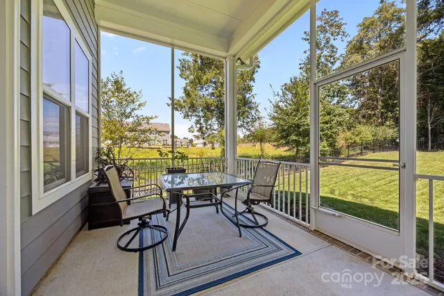 a view of a two chairs and table in the balcony