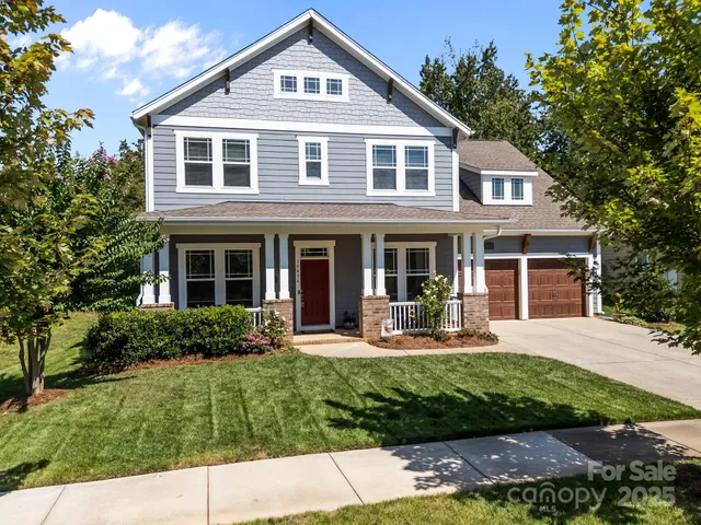 a front view of a house with a yard and porch
