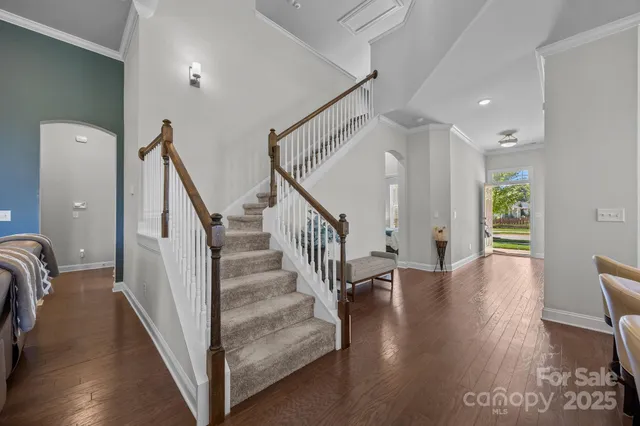 a view of entryway with wooden floor and stairs