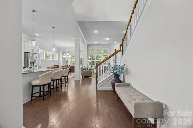 a view of entryway with wooden floor and stairs