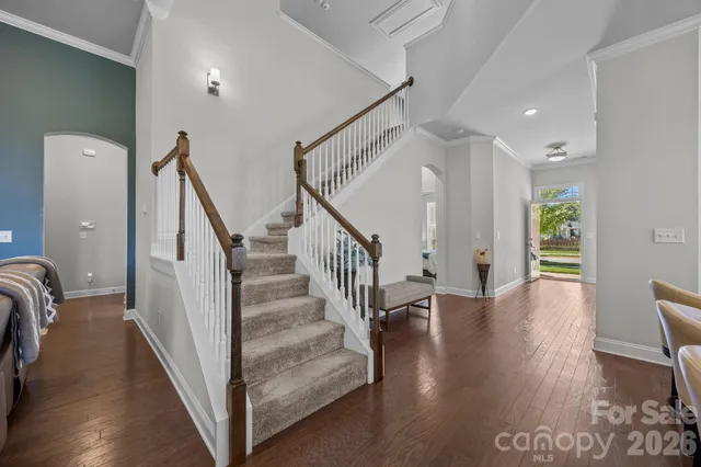 a kitchen with a table chairs stove and white cabinets