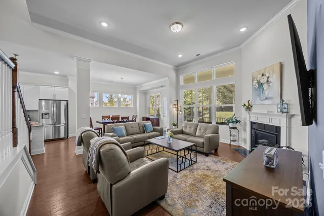 a living room with furniture fireplace and flat screen tv