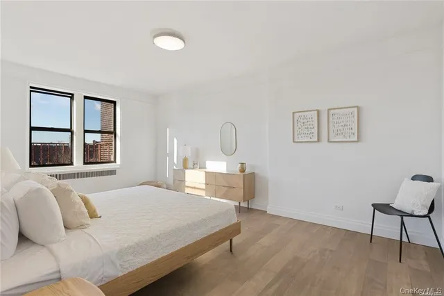 a bedroom with a bed chair and window