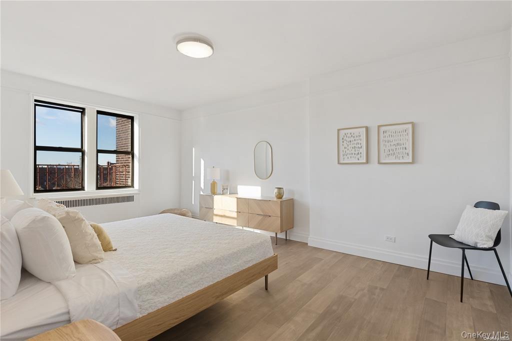 40-35 Ithaca Street, Unit 6F Queens, NY 11373 - Photo 5 of 10 a bedroom with a bed chair and window