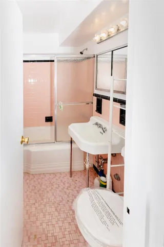 a living room with furniture a table and kitchen view