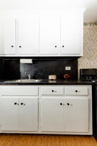 a kitchen with a sink and cabinets