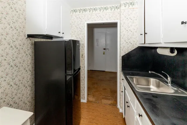 a kitchen with a sink and a refrigerator