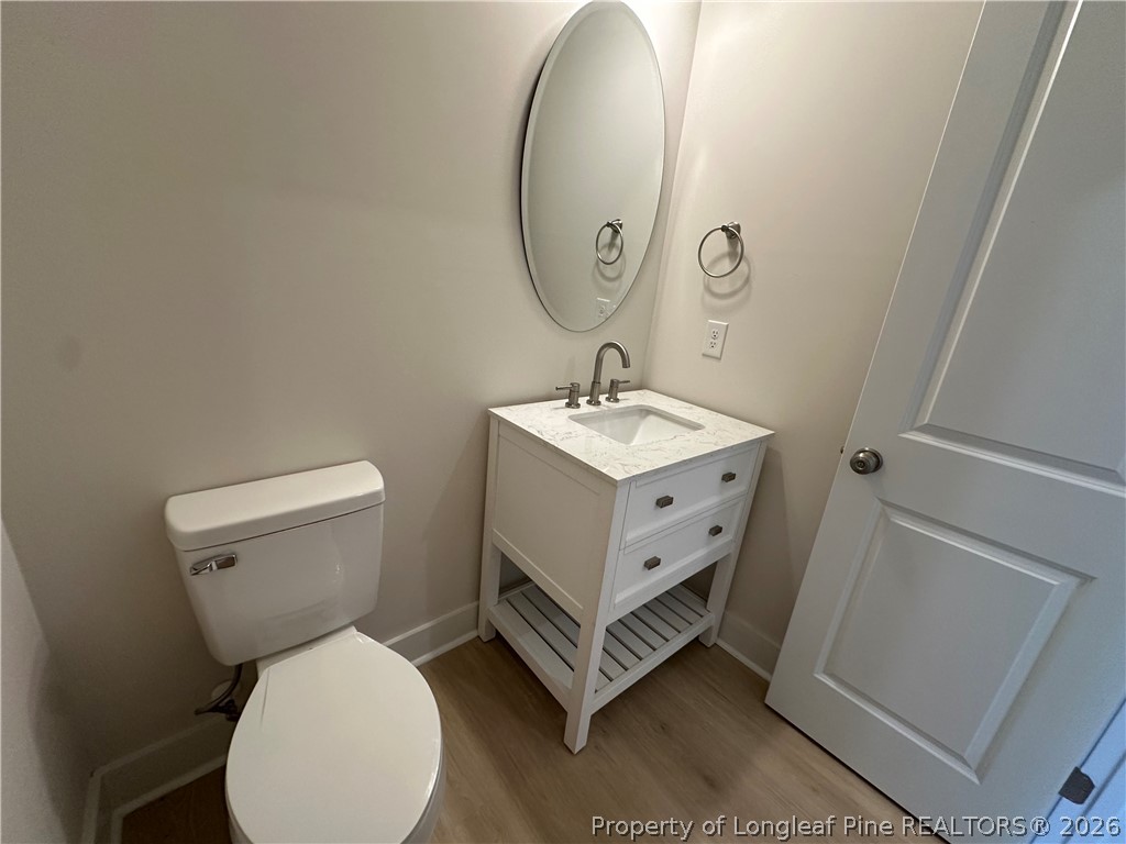 2908 Calloway Road Raeford, NC 28376 - Photo 5 of 25 a bathroom with a toilet sink and mirror