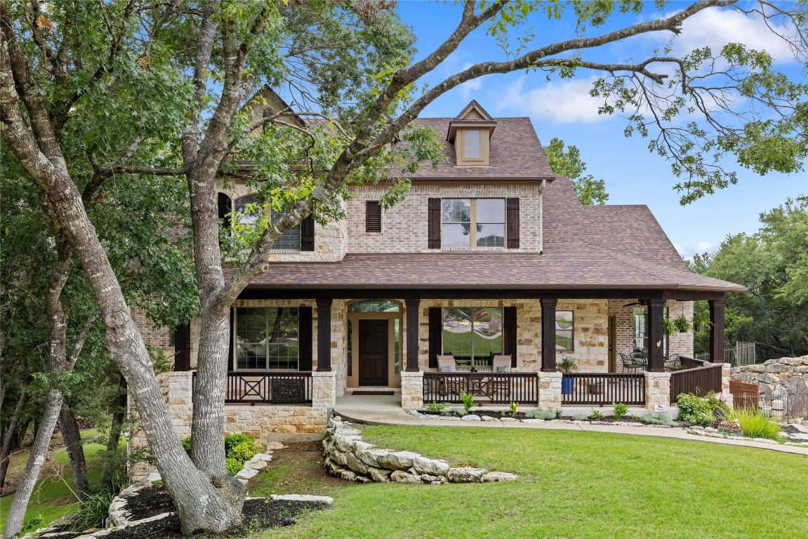 a front view of a house with swimming pool and chairs