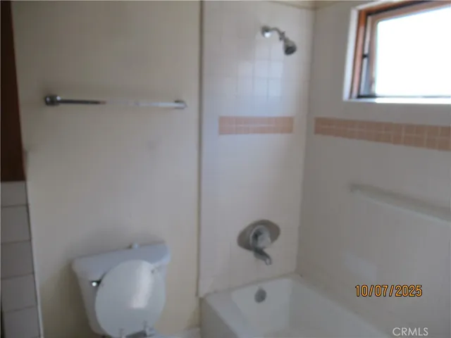 a view of staircase with railing and a chandelier