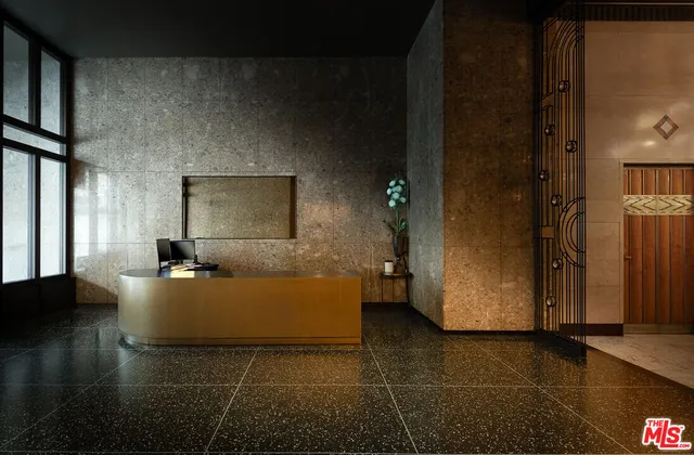 a view of a hallway with couches and chandelier