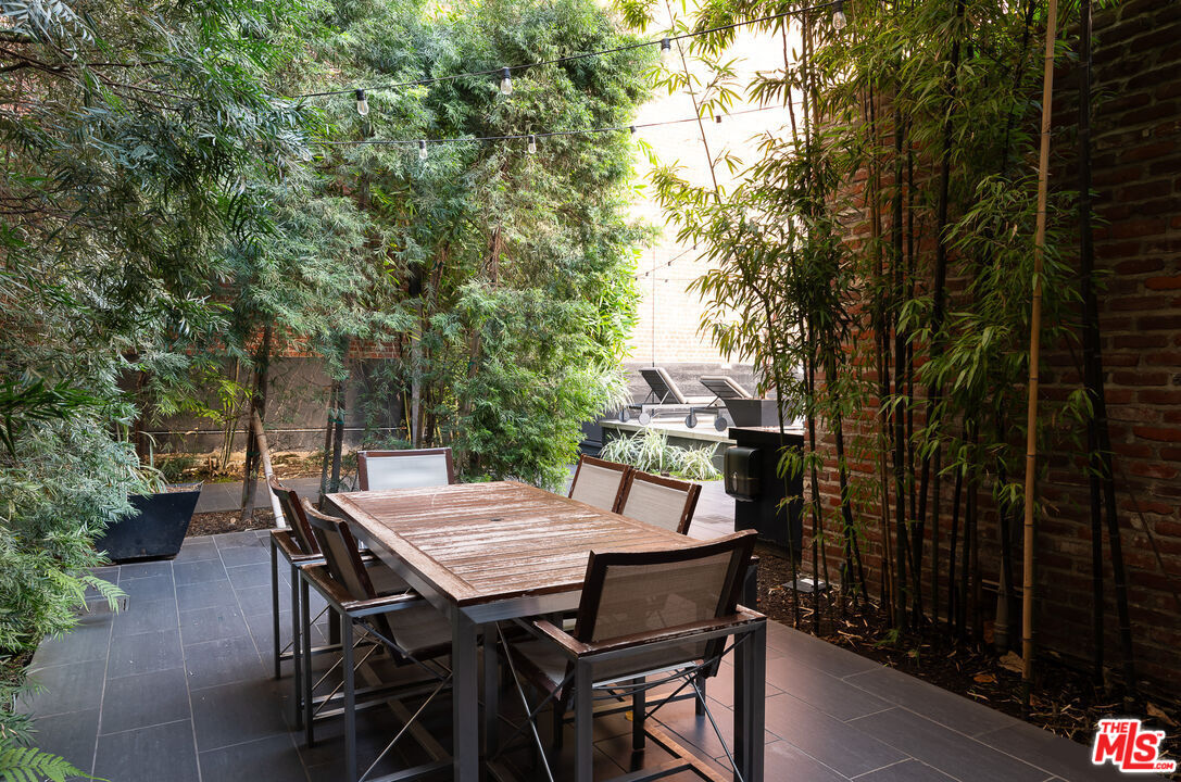 460 South Spring Street, Unit 1211 Los Angeles, CA 90013 - Photo 24 of 26 a view of a backyard with table and chairs and potted plants