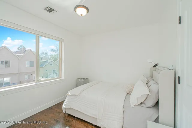a bedroom with a bed and a large window