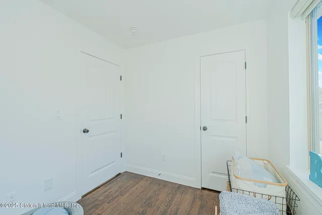 a view of a room with wooden floor