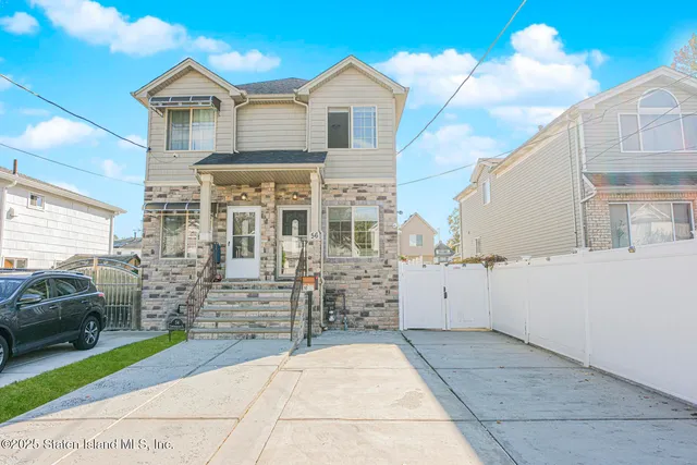 a view of a house with a wooden fence