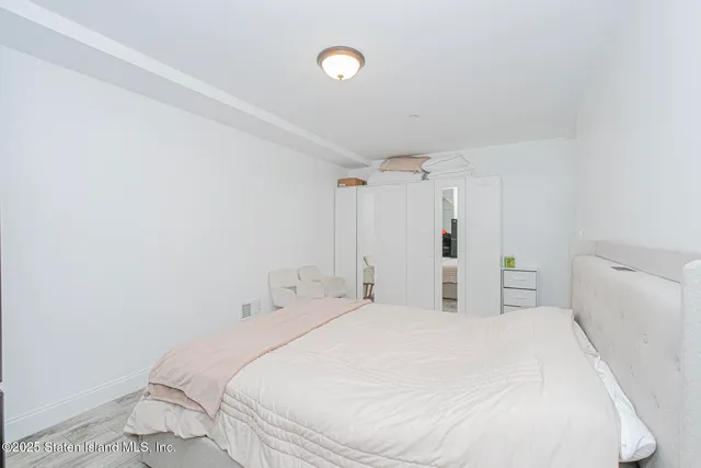 a bedroom with a bed and a shower