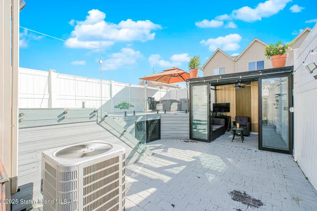 a view of a white house with table and chairs