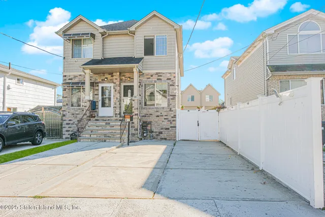 a view of a brick house with many windows