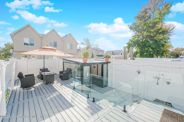 a view of a patio with furniture and a barbeque
