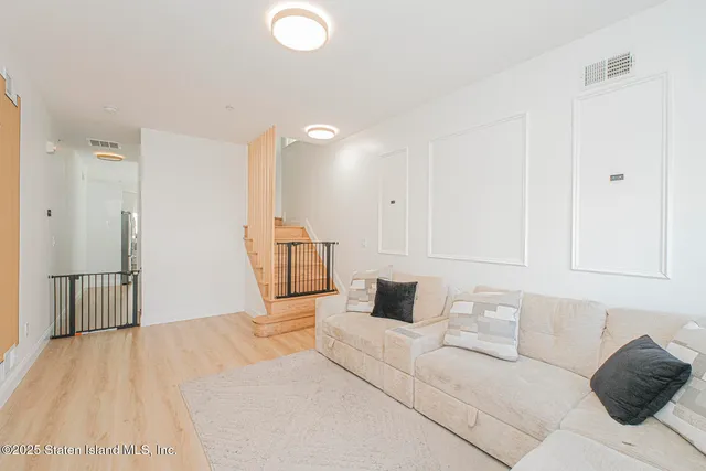a bedroom with a large bed and wooden floor