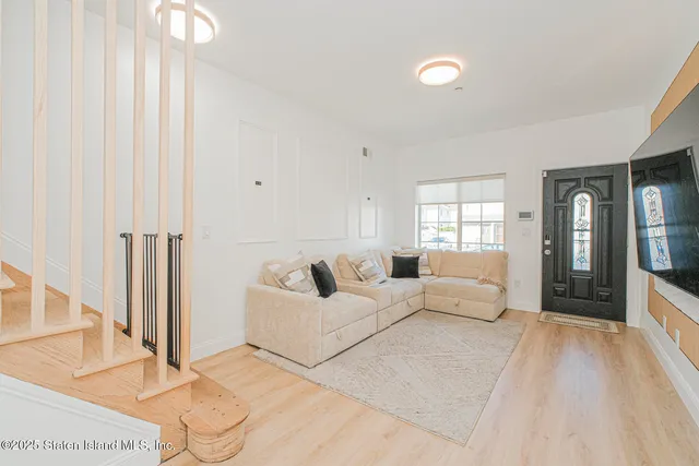 a living room with furniture window and wooden floor