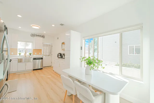 a large white kitchen with a large window