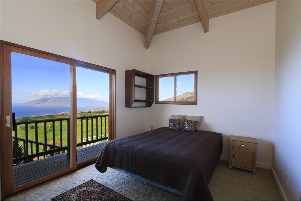 13434 Kula Highway Kula, HI 96790 - Photo 12 of 30 a bedroom with a bed next to a window