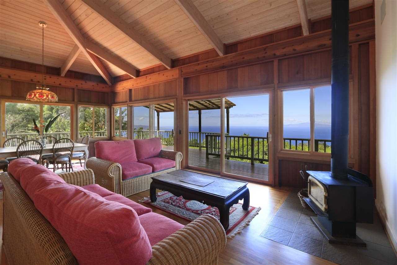 13434 Kula Highway Kula, HI 96790 - Photo 2 of 30 a living room with furniture a ceiling fan and a floor to ceiling window
